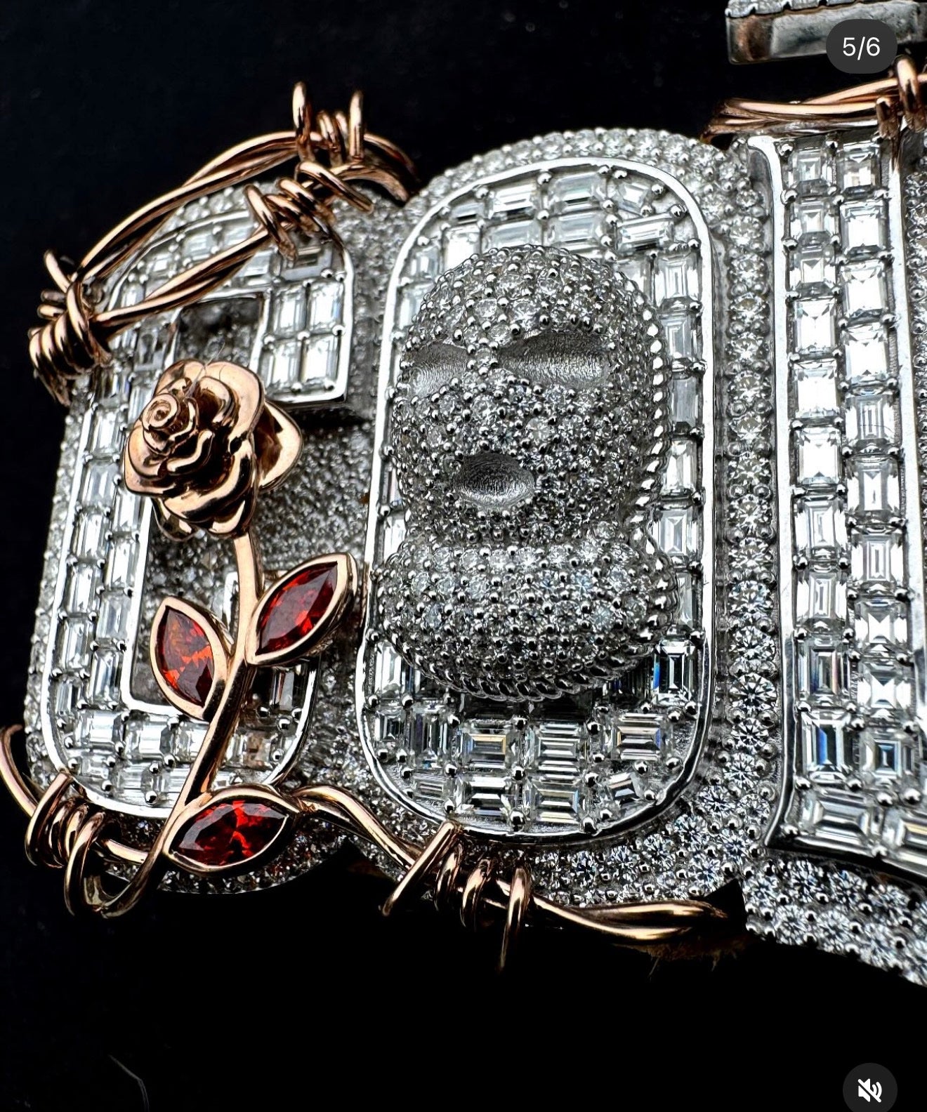 Close-up of rose-gold rose and red stone buds on a custom Mars Jewelers pendant