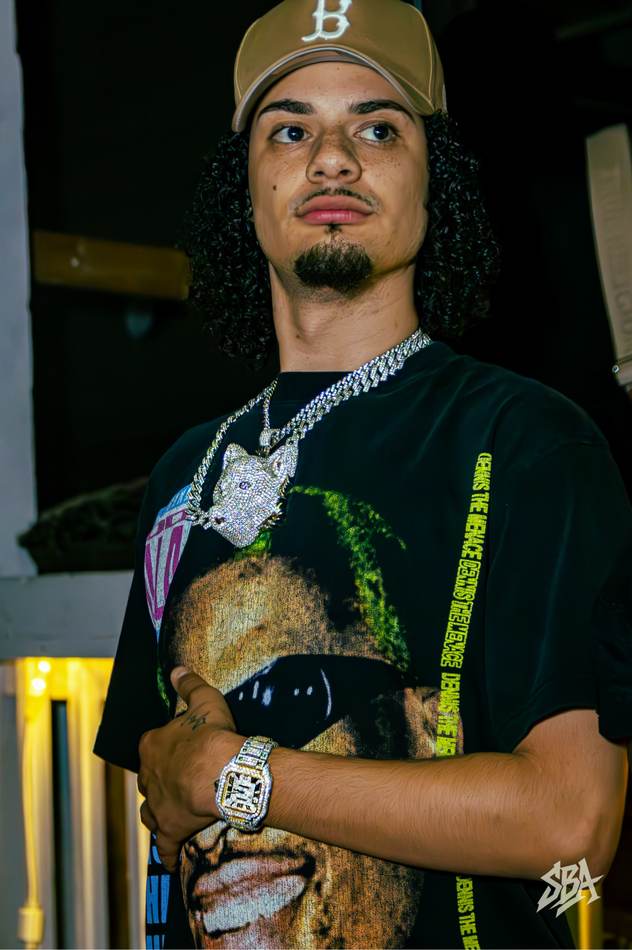 Mars, the jeweler behind Mars Jewelers, wearing his custom wolf pendant