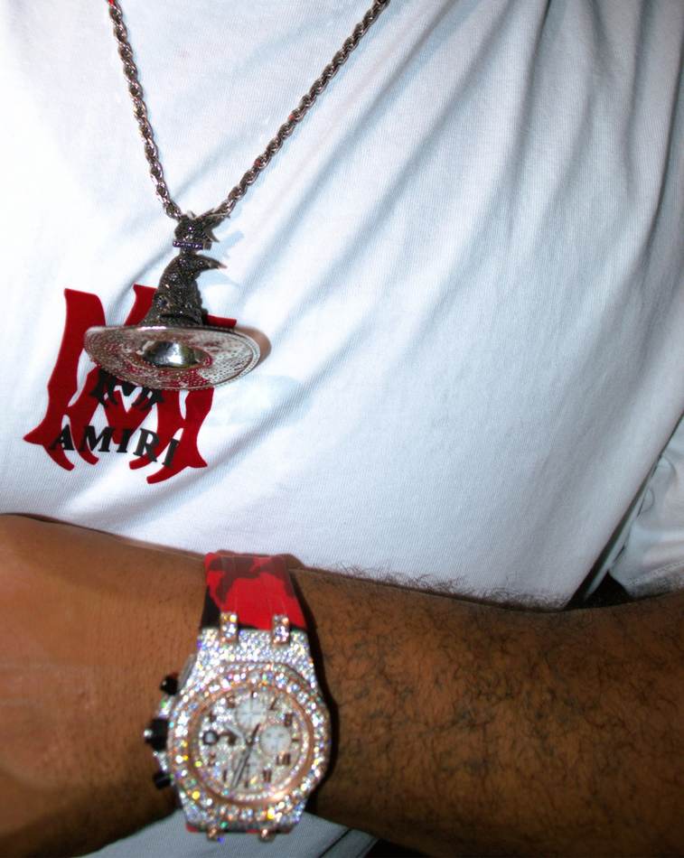 Client wearing a custom wizard pendant and iced watch